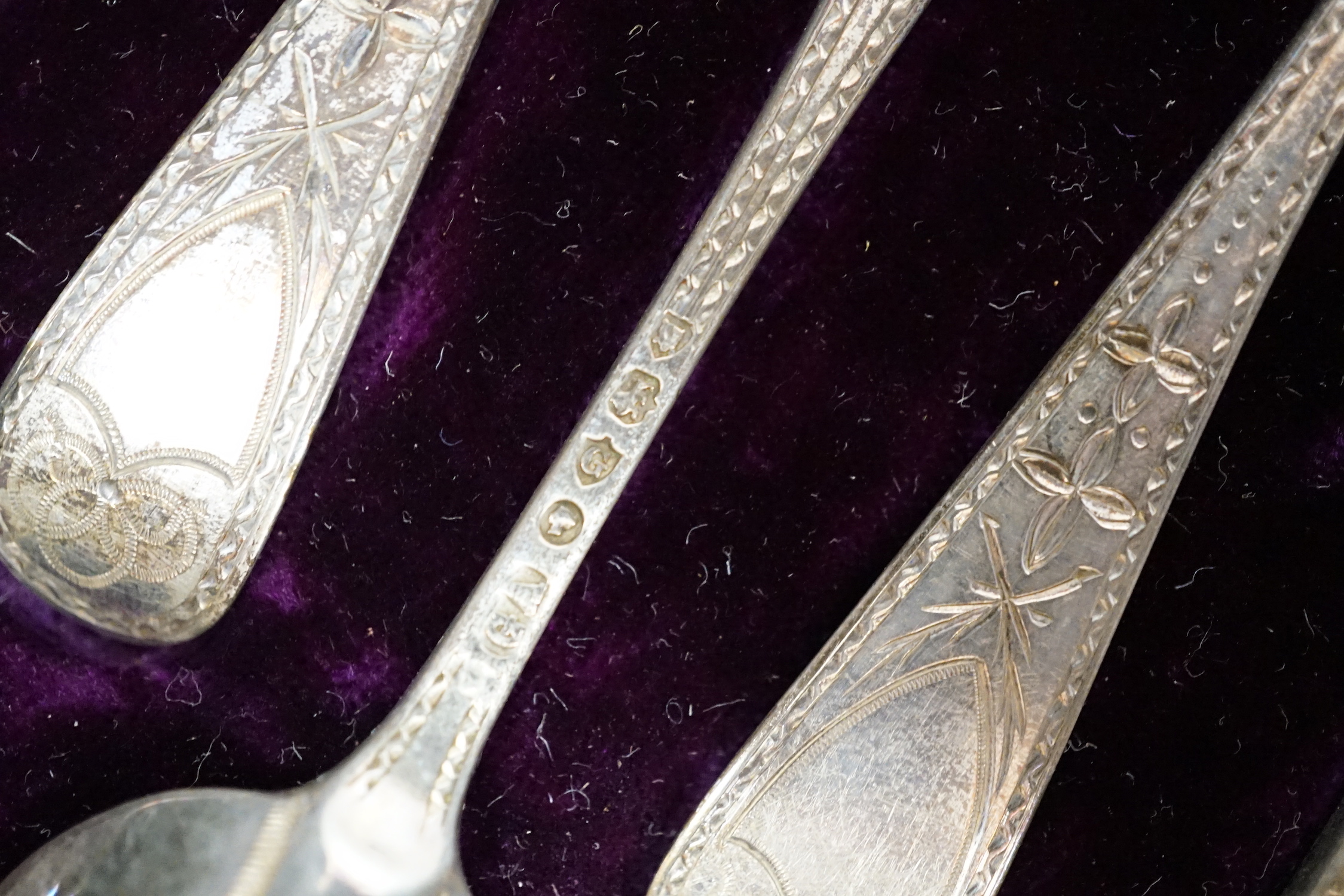 A cased set of twelve Victorian engraved silver rat tail pattern teaspoons with sugar tongs, George Adams, London, 1882.